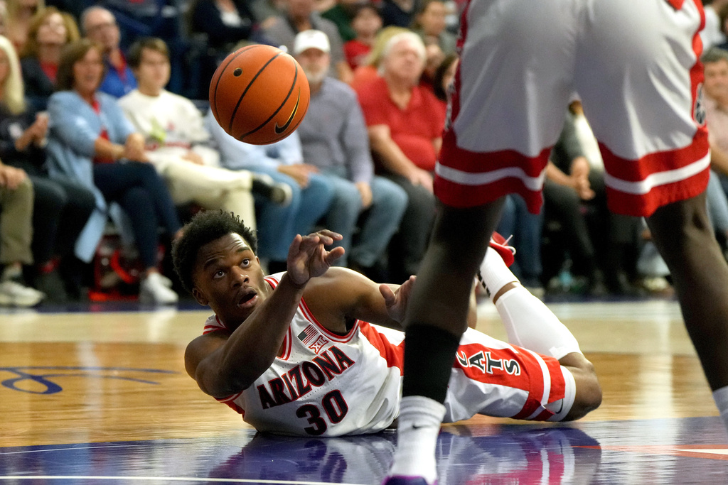 Arizona forward Tobe Awaka (30) saves the ball during the first half of an NCAA college basketball game against Utah Tech, Friday, Nov. 7, 2025, in Tucson, Ariz. (AP Photo/Rick Scuteri)