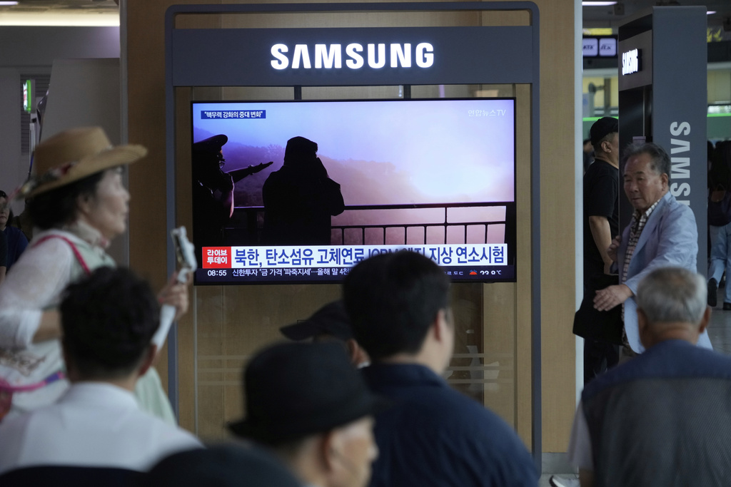 A TV screen shows an image of North Korean leader Kim Jong Un, second from right, supervising a test of a new rocket engine during a news program at the Seoul Railway Station in Seoul, South Korea, Tuesday, Sept. 9, 2025. (AP Photo/Ahn Young-joon)