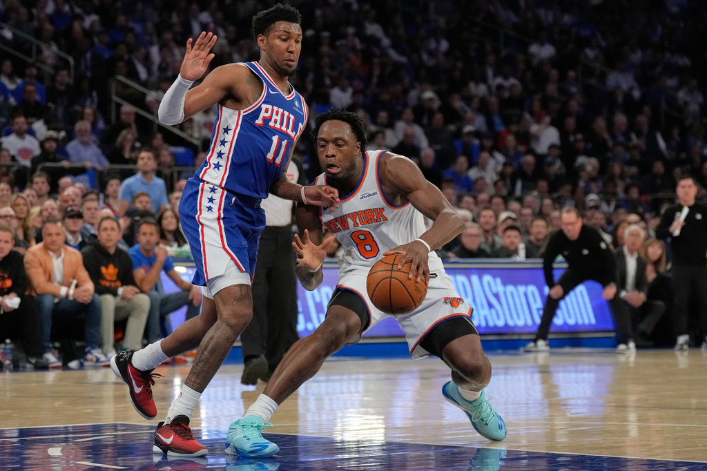 New York Knicks' Og Anunoby, right, drives past Philadelphia 76ers' Justin Edwards during the first half of Game 1 in a second-round NBA basketball playoffs series Monday, May 4, 2026, in New York. (AP Photo/Seth Wenig)