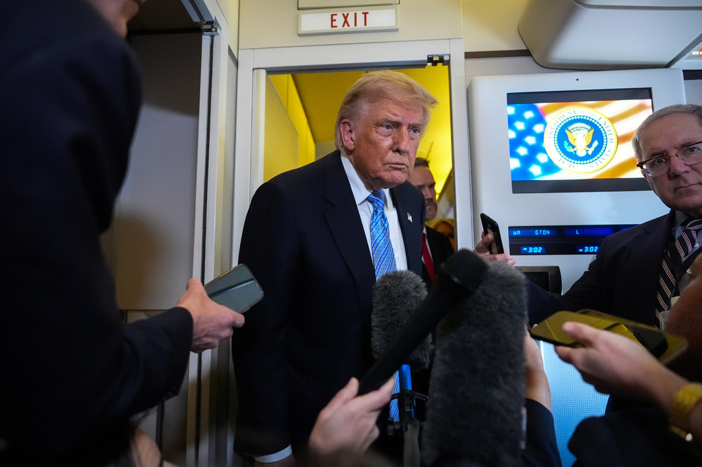 President Donald Trump speaks to reporters aboard Air Force One, Friday, May 15, 2026, as he returns from a trip to Beijing, China. (AP Photo/Mark Schiefelbein)