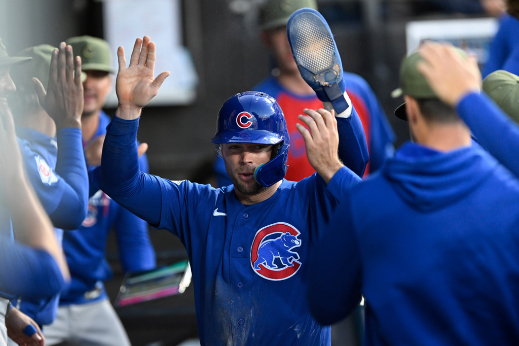Chicago Cubs' Nico Hoerner celebrates with teammates in the dugout after scoring on a Michael Busch double during the fifth inning of a baseball game against the Chicago White Sox in Chicago, Friday, May 15, 2026. (AP Photo/Paul Beaty)