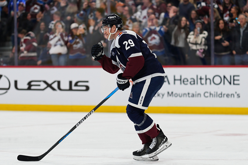 Colorado Avalanche center Nathan MacKinnon celebrates as he skates back to the team box after scoring a goal against the St. Louis Blues in the first period of an NHL hockey game Wednesday, Dec. 31, 2025, in Denver. (AP Photo/David Zalubowski)