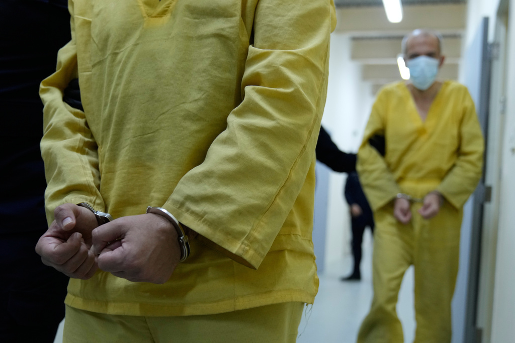 Iraqi security forces lead suspected Islamic State militants for questioning, after they were transferred from Syria to Iraq, at Al-Karkh Central Prison in Baghdad, Iraq, Thursday, Feb. 12, 2026. (AP Photo/Hadi Mizban)