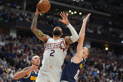 Phoenix Suns center Nick Richards, center, goes up for a basket as Denver Nuggets forwards Aaron Gordon, left, and Christian Braun, right, defend in the first half of an NBA basketball game Saturday, Oct. 25, 2025, in Denver. (AP Photo/David Zalubowski) Phoenix Suns center Nick Richards, center, goes up for a basket as Denver Nuggets forwards Aaron Gordon, left, and Christian Braun, right, defend in the first half of an NBA basketball game Saturday, Oct. 25, 2025, in Denver. (AP Photo/David Zalubowski)