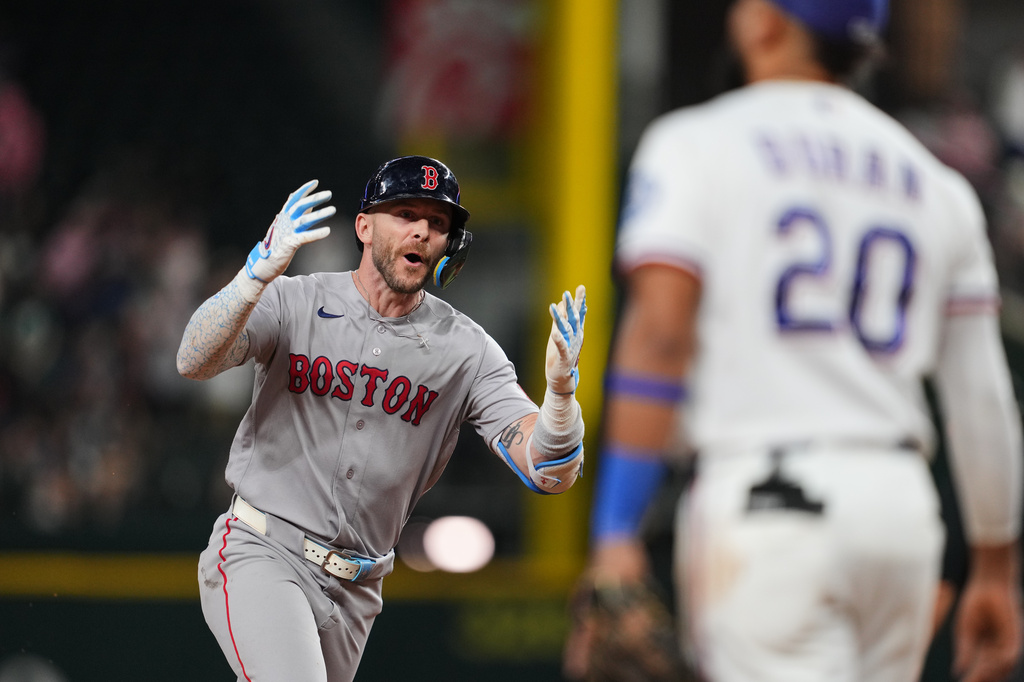 Boston Red Sox's Trevor Story celebrates his three-run home run as he jogs past Texas Rangers' Ezequiel Duran (20) in the eighth inning of a baseball game Thursday, Sept. 17, 2026, in Arlington, Texas (AP Photo/Tony Gutierrez)