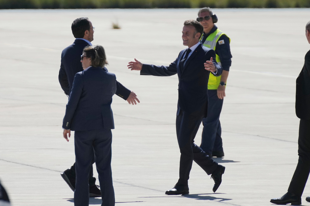 French President Emmanuel Macron, right, is welcomed by Cyprus President Nikos Christodoulides, left, at Andreas Papandreou Air Base in Paphos, Cyprus, on Monday, March 9, 2026. (AP Photo/Petros Karadjias)