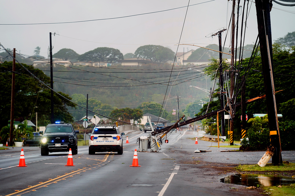 Downed power lines caused by Hurricane Lowell are seen across a road Tuesday, Sept. 8, 2026, in Hanapēpē, Kauaʻi, Hawaii. (Kevin Fujii/Honolulu Civil Beat via AP) CORRECTION: Location corrected from in Poʻipū on Kauaʻi's south shore to Hanapēpē.