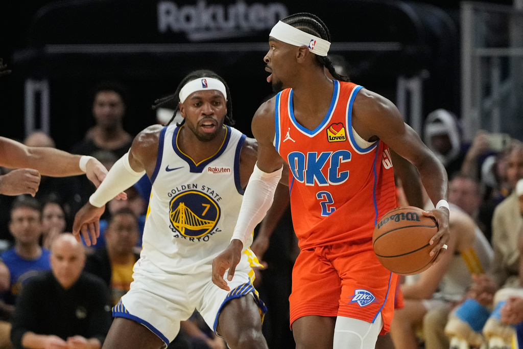Oklahoma City Thunder guard Shai Gilgeous-Alexander (2) brings the ball up the court against Golden State Warriors guard Buddy Hield (7) during the first half of an NBA basketball game in San Francisco, Tuesday, Dec. 2, 2025. (AP Photo/Jeff Chiu)