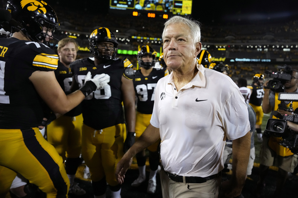 Iowa head coach Kirk Ferentz, right, walks off the field after an NCAA college football game against Massachusetts, Saturday, Sept. 13, 2025, in Iowa City, Iowa. (AP Photo/Charlie Neibergall)