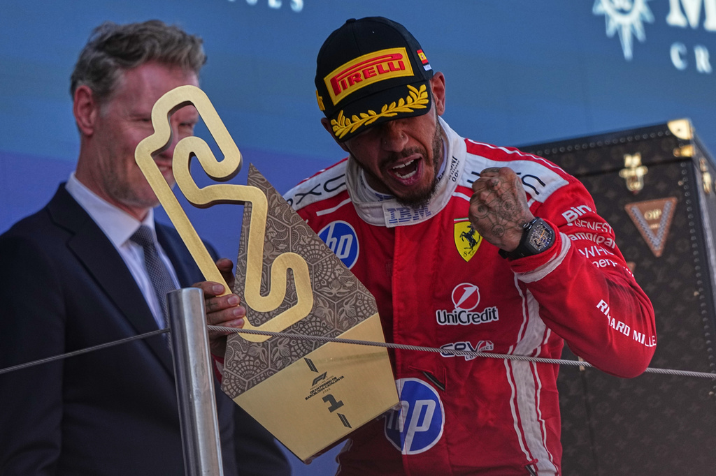 Ferrari driver Lewis Hamilton of Britain celebrates after wining the Spain F1 Grand Prix race at the Barcelona Catalunya racetrack in Montmelo, near Barcelona, Spain, Sunday, June 14, 2026. (AP Photo/Fatima Shbair)