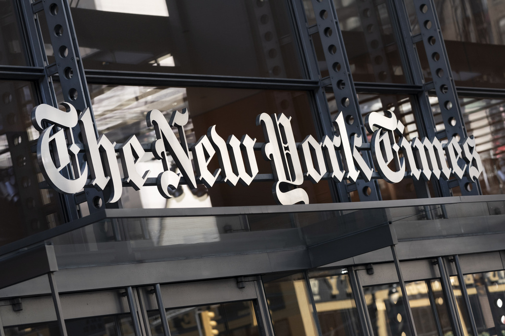 FILE - A sign for The New York Times hangs above the entrance to its building in New York, May 6, 2021. (AP Photo/Mark Lennihan, File)