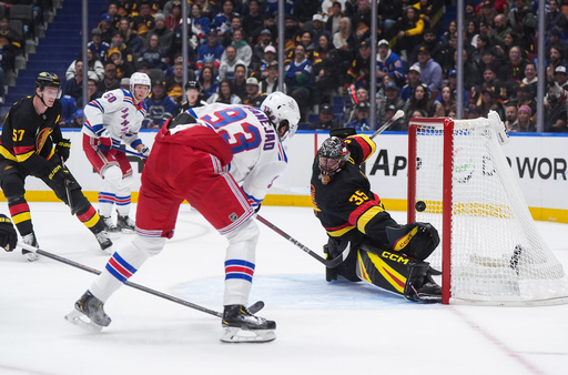 New York Rangers' Mika Zibanejad (93) scores against Vancouver Canucks goalie Thatcher Demko (35) during the first period of an NHL hockey game in Vancouver, on Tuesday, Oct. 28, 2025. (Darryl Dyck/The Canadian Press via AP) New York Rangers' Mika Zibanejad (93) scores against Vancouver Canucks goalie Thatcher Demko (35) during the first period of an NHL hockey game in Vancouver, on Tuesday, Oct. 28, 2025. (Darryl Dyck/The Canadian Press via AP)