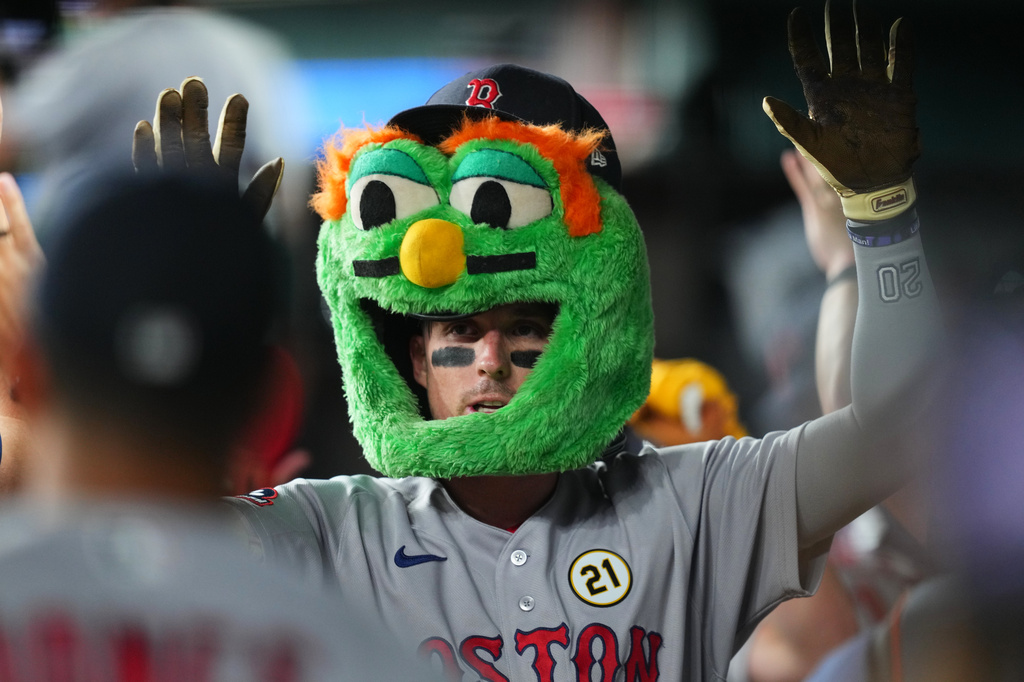 Boston Red Sox's Nick Sogard is greeted in the dugout after hitting a two-run home run off Texas Rangers pitcher Jacob deGrom during the third inning of a baseball game Tuesday, Sept. 15, 2026, in Arlington, Texas. (AP Photo/Julio Cortez)