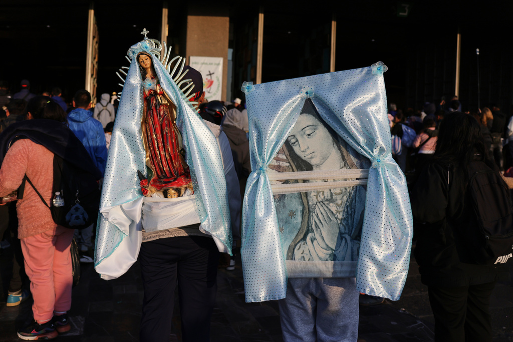 People carry images of the Virgin of Guadalupe to the Basilica of Our Lady of Guadalupe in Mexico City, on her feast day, Friday, Dec. 12, 2025. (AP Photo/Claudia Rosel)