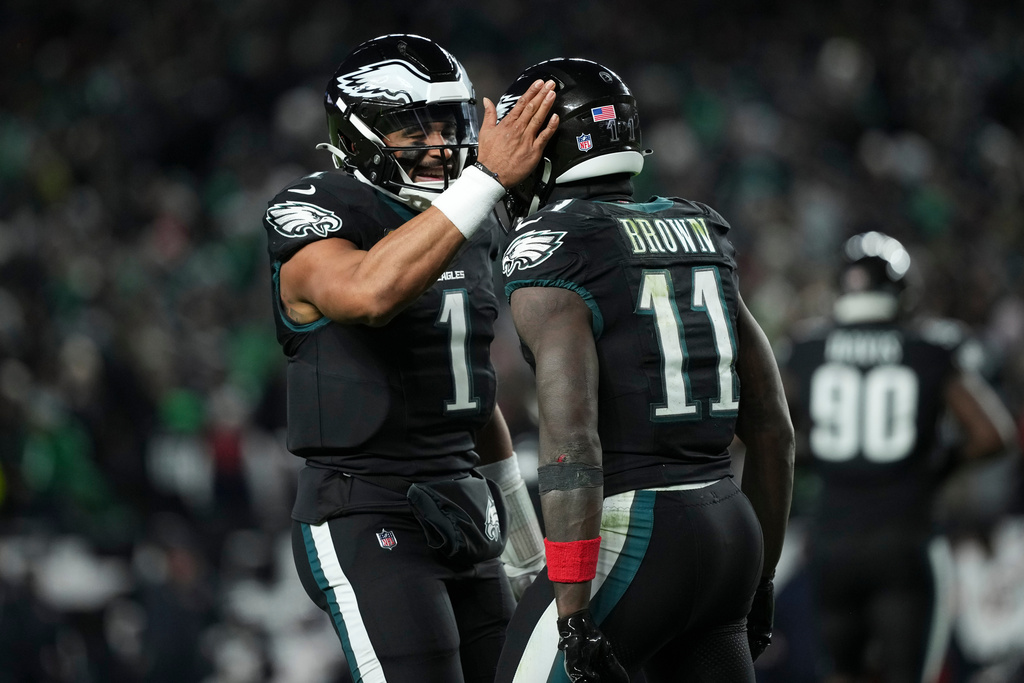 Philadelphia Eagles wide receiver A.J. Brown (11), right, celebrates his touchdown with quarterback Jalen Hurts (1) during the second half of an NFL football game against the Chicago Bears, Friday, Nov. 28, 2025, in Philadelphia. (AP Photo/Matt Slocum)