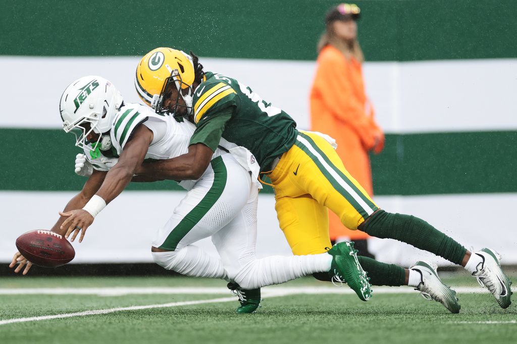 New York Jets wide receiver Isaiah Williams (18) is tackled by Green Bay Packers wide receiver J. Michael Sturdivant (87) during an NFL football game in East Rutherford, N.J., Sunday, Sept. 20, 2026. (AP Photo/Adam Hunger)