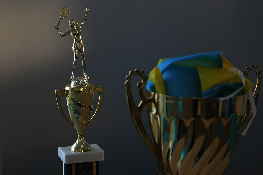 A trophy and the flag of Ukraine belonging to Mariia Vainshtein sits on a table at the Cary Leeds Center for Tennis and Learning in the Bronx borough of New York, Saturday, Jan. 31, 2026. (AP Photo/Heather Khalifa)