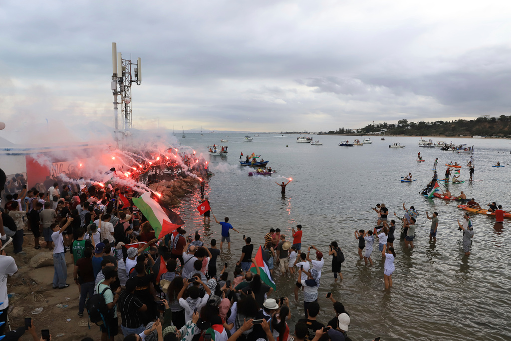 People gather to show support for the Global Sumud Flotilla ahead of its scheduled departure to deliver aid to Gaza amidst Israel's blockade on the Palestinian territory, in Sidi Bou Said port, in Tunis, Tunisia, Wednesday, Sept. 10, 2025. (AP Photo/Anis Mili)