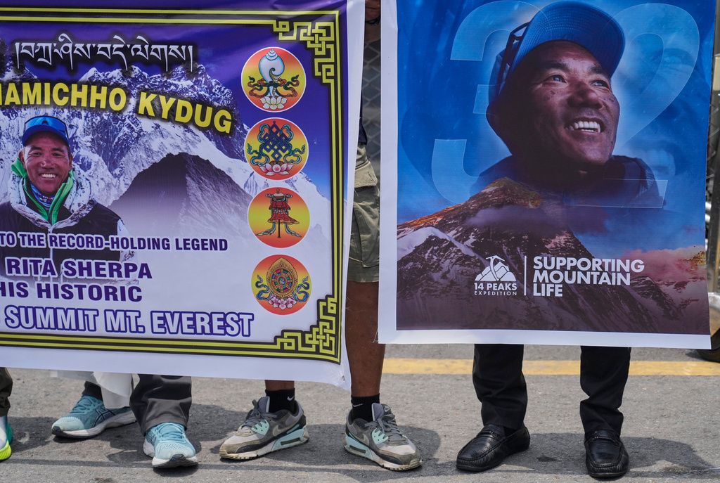 Friends and family members wait as renowned Sherpa mountain guide Kami Rita, returning from Mount Everest after his record 32nd successful ascent, arrives in Kathmandu, Nepal, Friday, May 22, 2026. (AP Photo/Niranjan Shrestha)