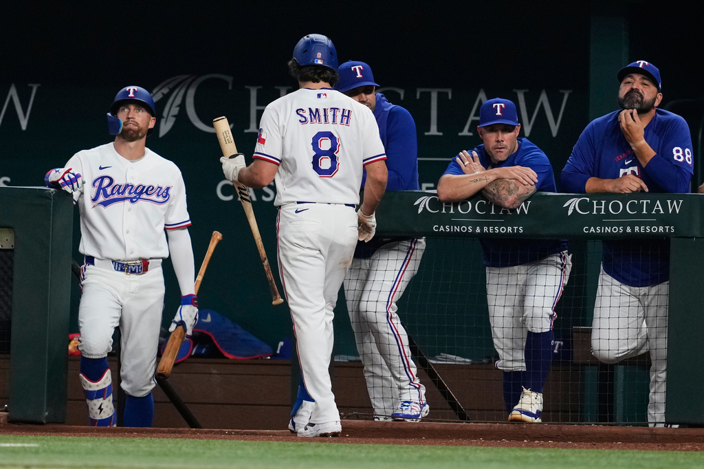 Texas Rangers' Josh Smith (8) walks to the dugout after striking out in the fifth inning of a baseball game against the New York Yankees Tuesday, April 28, 2026, in Arlington, Texas. (AP Photo/Tony Gutierrez)