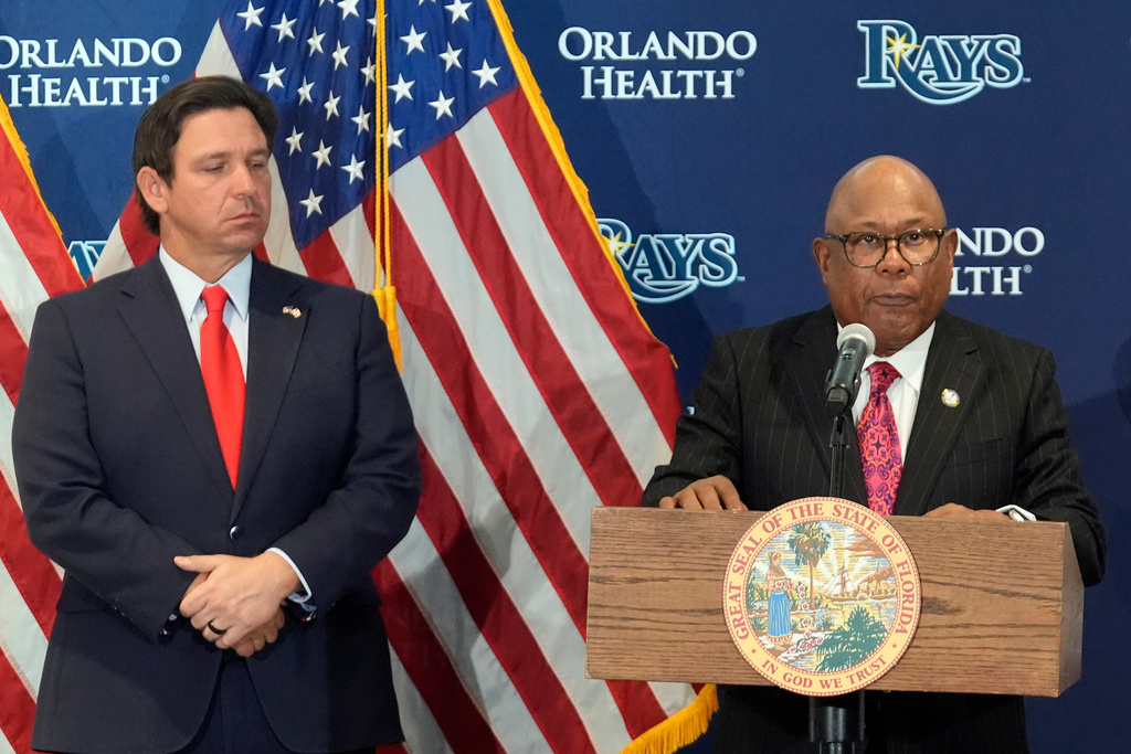 Hillsborough College president Dr. Ken Atwater, right, speaks during a new baseball stadium news conference as Florida Gov. Ron DeSantis looks on at Hillsborough College, Tuesday, Feb. 3, 2026, in Tampa, Fla. (AP Photo/Chris O'Meara)