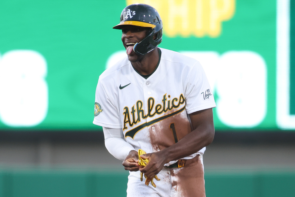Athletics' Denzel Clarke sticks his tongue out after hitting a double during the third inning of a baseball game against the Texas Rangers, Tuesday, April 14, 2026, in West Sacramento, Calif. (AP Photo/Scott Marshall)