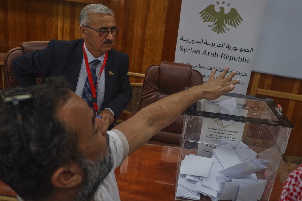 A voter casts a ballot during follow-up parliamentary elections in Hassakeh, northeastern Syria, Sunday, May 24, 2026. (AP Photo/Baderkhan Ahmad)