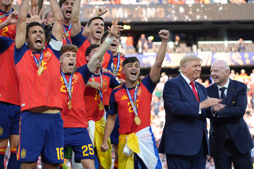 Spain players, from left, cheer alongside President Donald Trump and FIFA President Gianni Infantino at the conclusion of the World Cup championship final soccer match between Spain and Argentina in East Rutherford, N.J., Sunday, July 19, 2026. (AP Photo/Jacquelyn Martin)