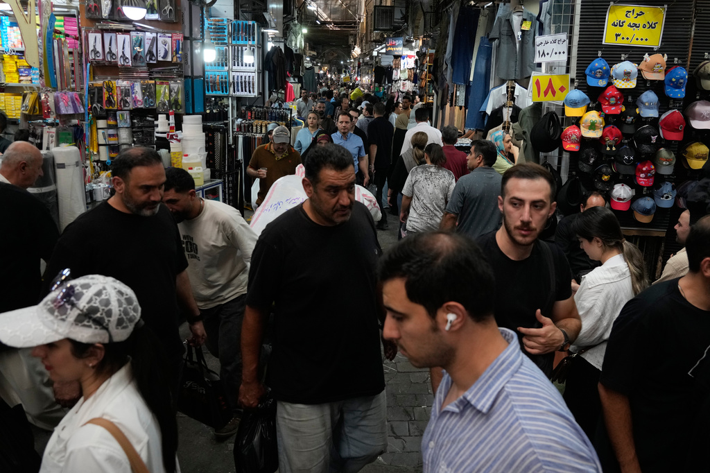 People walk in Tehran's traditional main bazaar, Iran, Saturday, Aug. 8, 2026. (AP Photo/Vahid Salemi)