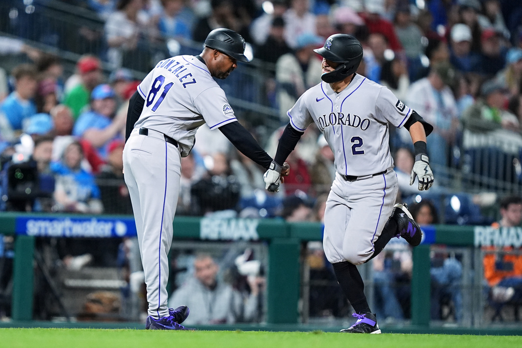 Colorado Rockies' Tyler Freeman (2) celebrates his home run off of Philadelphia Phillies pitcher Tim Mayza with Colorado Rockies third base coach Andy González during the seventh inning of a baseball game, Friday, May 8, 2026, in Philadelphia. (AP Photo/Matt Rourke)