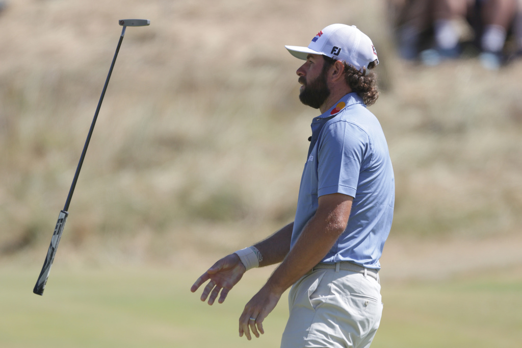Cameron Young of the United States tosses his club after missing a putt on the 7th green during the final day of the British Open Golf championships at Royal Birkdale golf club, in Southport, England, Sunday, July 19, 2026. (AP Photo/Peter Morrison)