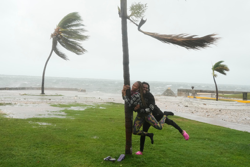A couple jokes around on the coast in Kingston, Jamaica, as Hurricane Melissa approaches, Tuesday, Oct. 28, 2025. (AP Photo/Matias Delacroix) A couple jokes around on the coast in Kingston, Jamaica, as Hurricane Melissa approaches, Tuesday, Oct. 28, 2025. (AP Photo/Matias Delacroix)