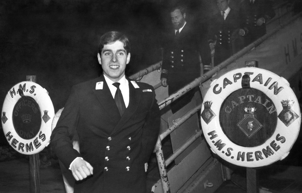 FILE- Prince Andrew strides along the dock at Pensacola Naval Base in Pensacola, Florida on Feb. 23, 1980 as he prepares for shore leave. Prince Andrews is stationed aboard the HMS Hermes and undergoing training at the facility. (AP Photo/MB, File)