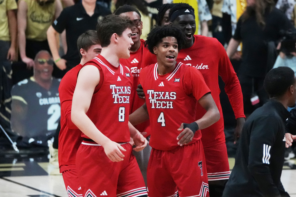 Texas Tech guard Nolan Groves, front left, congratulates guard Christian Anderson (4) after Anderson hit a 3-point basket as time ran out in the first half of an NCAA college basketball game against Colorado, Saturday, Jan. 10, 2026, in Boulder, Colo. (AP Photo/David Zalubowski)