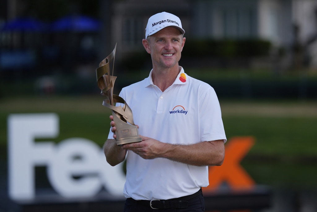 Justin Rose, of England, holds the trophy after winning the St. Jude Championship golf tournament Sunday, Aug. 10, 2025, in Memphis, Tenn. (AP Photo/George Walker IV)