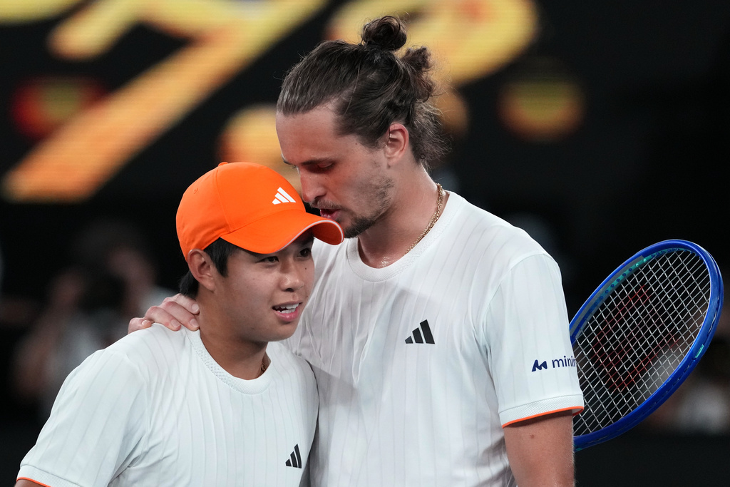 Alexander Zverev, right, of Germany is congratulated by Learner Tien, left, of the U.S. following their quarterfinal match at the Australian Open tennis championship in Melbourne, Australia, Tuesday, Jan. 27, 2026. (AP Photo/Aaron Favila)