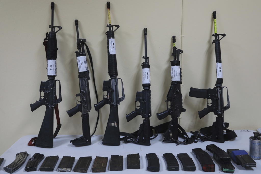 Weapons that police say were seized from alleged gang members sit on display for the media during a press conference at police headquarters in Port-au-Prince, Haiti, Tuesday, Aug. 26, 2025.(AP Photo/Odelyn Joseph)