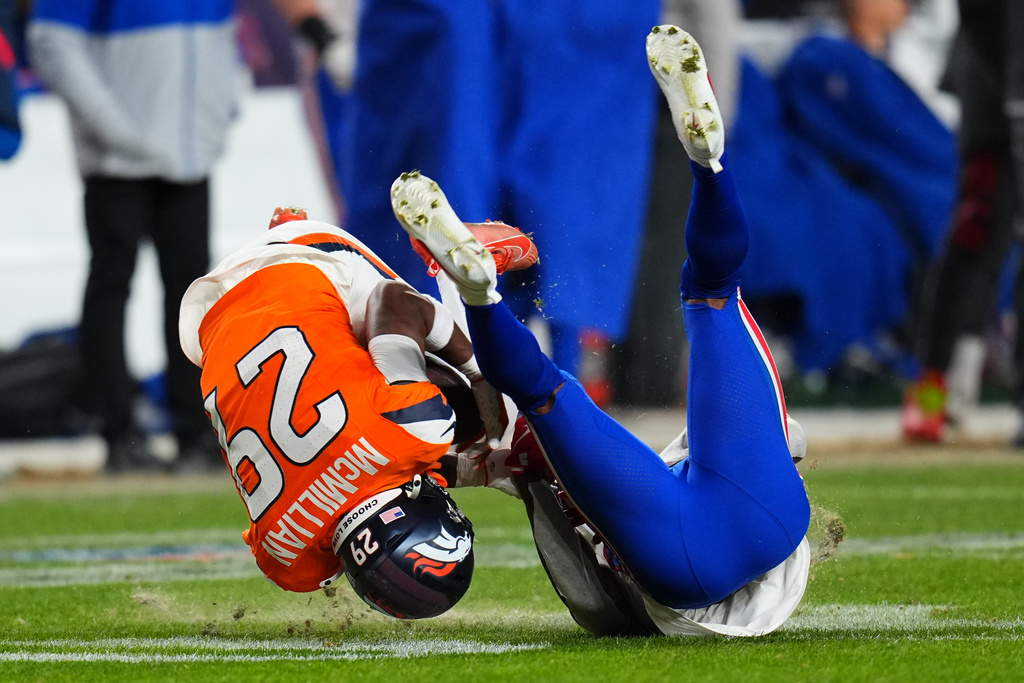 Denver Broncos cornerback Ja'quan McMillian (29) intercepts a pass intended for Buffalo Bills wide receiver Brandin Cooks (18) during overtime of an NFL divisional round playoff football game, Saturday, Jan. 17, 2026, in Denver. (AP Photo/Jack Dempsey)