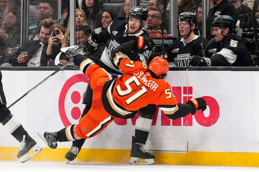 Los Angeles Kings left wing Jeff Malott, top, knocks Anaheim Ducks defenseman Olen Zellweger to the ice during the second period of an NHL hockey game Friday, Jan. 16, 2026, in Los Angeles. (AP Photo/Mark J. Terrill)