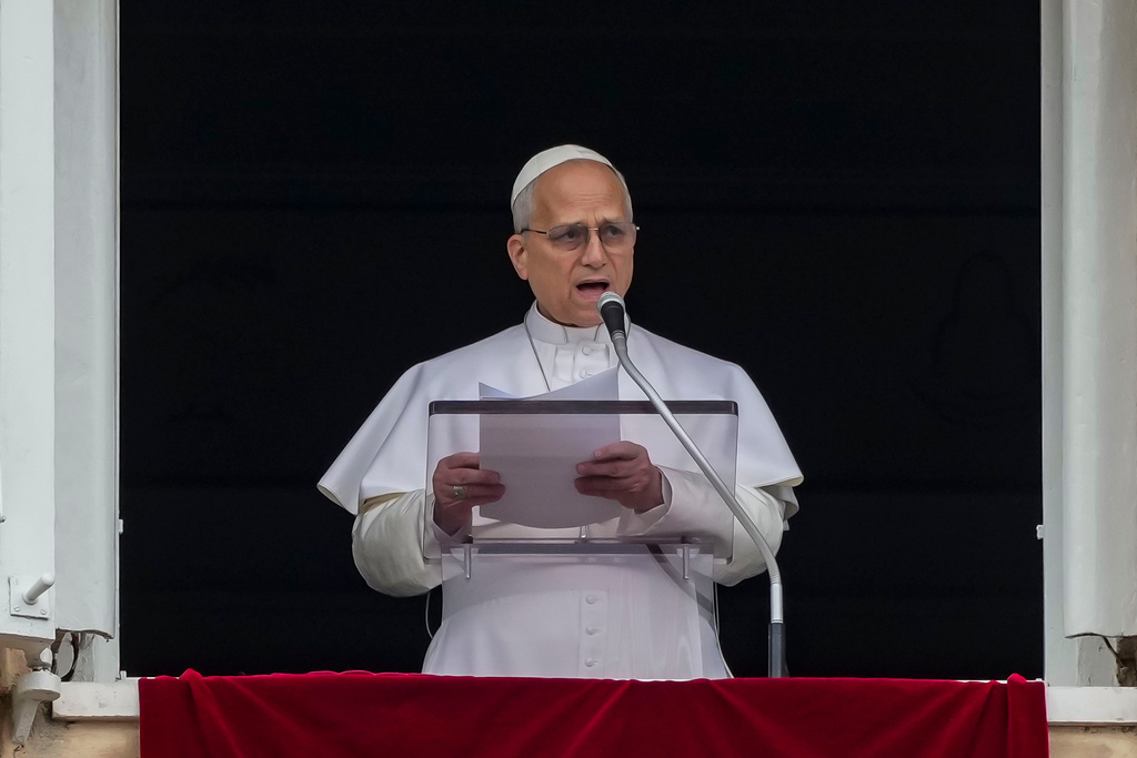 Pope Leo XIV appears at the window of his studio overlooking St. Peter's Square at the Vatican where Catholic faithful and pilgrims gathered for the traditional Sunday blessing at the end of the noon Angelus prayer, Sunday, March 15, 2026. (AP Photo/Andrew Medichini)