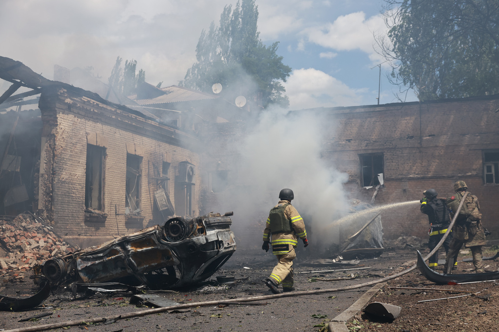 Rescue workers put out a fire at a building destroyed after a Russian strike on Zaporizhzhia, Ukraine, on Friday, June 26, 2026. (AP Photo/Evgeniy Maloletka)