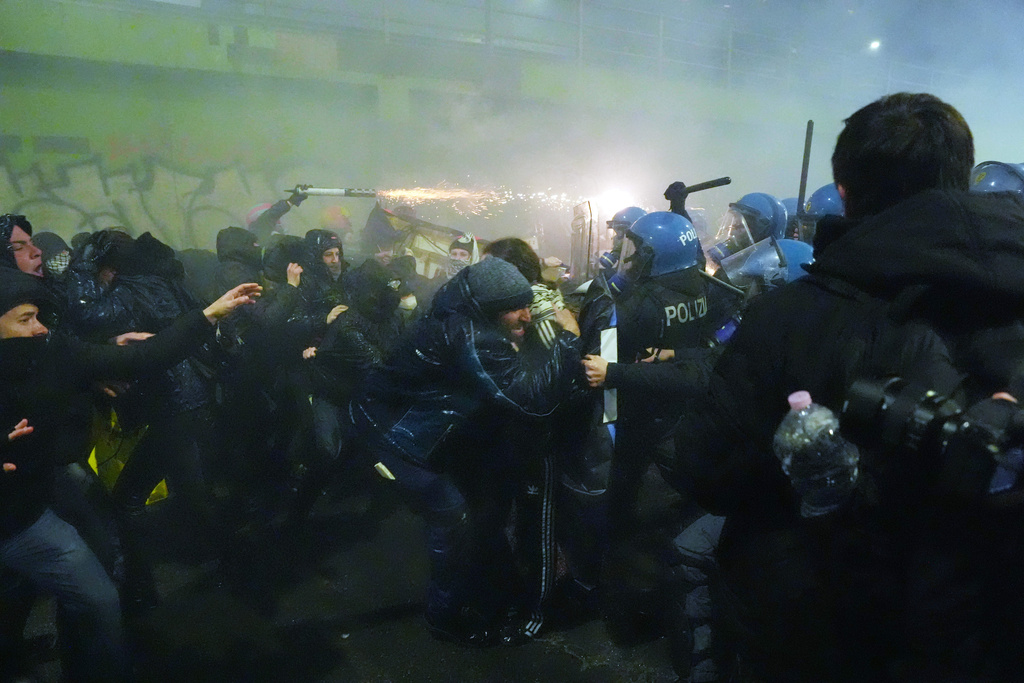 Demonstrators clash with police during a protest against the Milan-Cortina 2026 Olympics, in Milan, Italy, Saturday Feb. 7, 2026. (Claudio Furlan/LaPresse via AP)