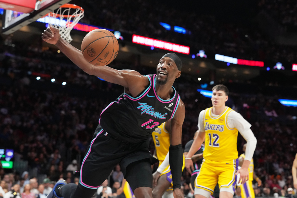 Miami Heat center Bam Adebayo (13) goes for a loose ball during the first half of an NBA basketball game against the Los Angeles Lakers, Thursday, March 19, 2026, in Miami. (AP Photo/Lynne Sladky)