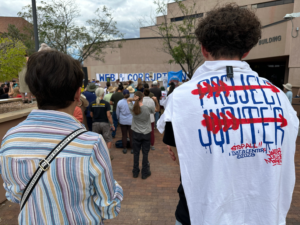 Protesters gather outside the New Mexico Environment Department to voice opposition to the Project Jupiter data center during a demonstration in Santa Fe, N.M., Friday, Aug. 21, 2026. (AP Photo/Susan Montoya Bryan)