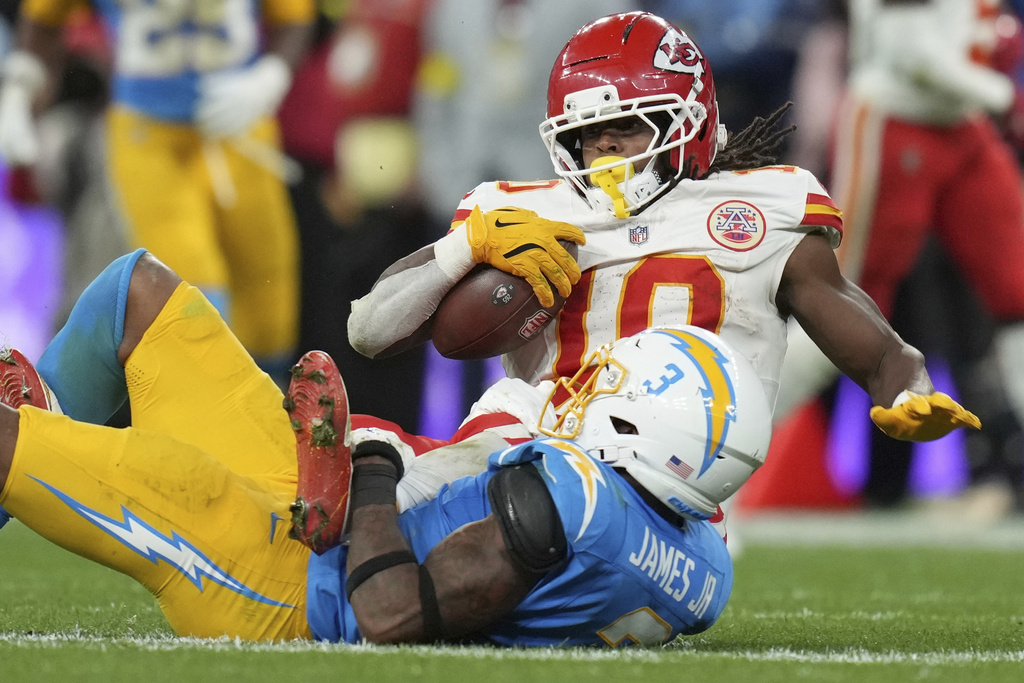 Kansas City Chiefs running back Isiah Pacheco is tackled by Los Angeles Chargers safety Derwin James Jr. during the second half of an NFL football game, Friday, Sept. 5, 2025, in Sao Paulo. (AP Photo/Andre Penner)