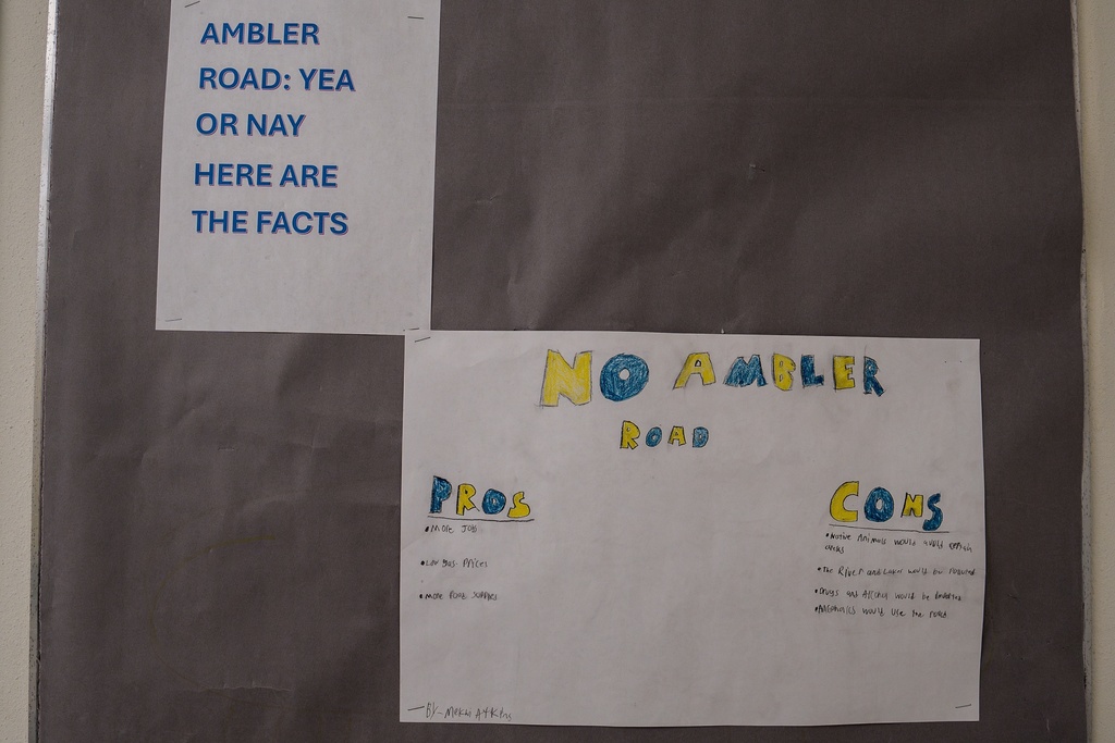 A pros and cons list of the Ambler Road hangs on the wall outside a classroom at Ambler School in Ambler, Alaska, Friday, Oct. 3, 2025. (AP Photo/Annika Hammerschlag)