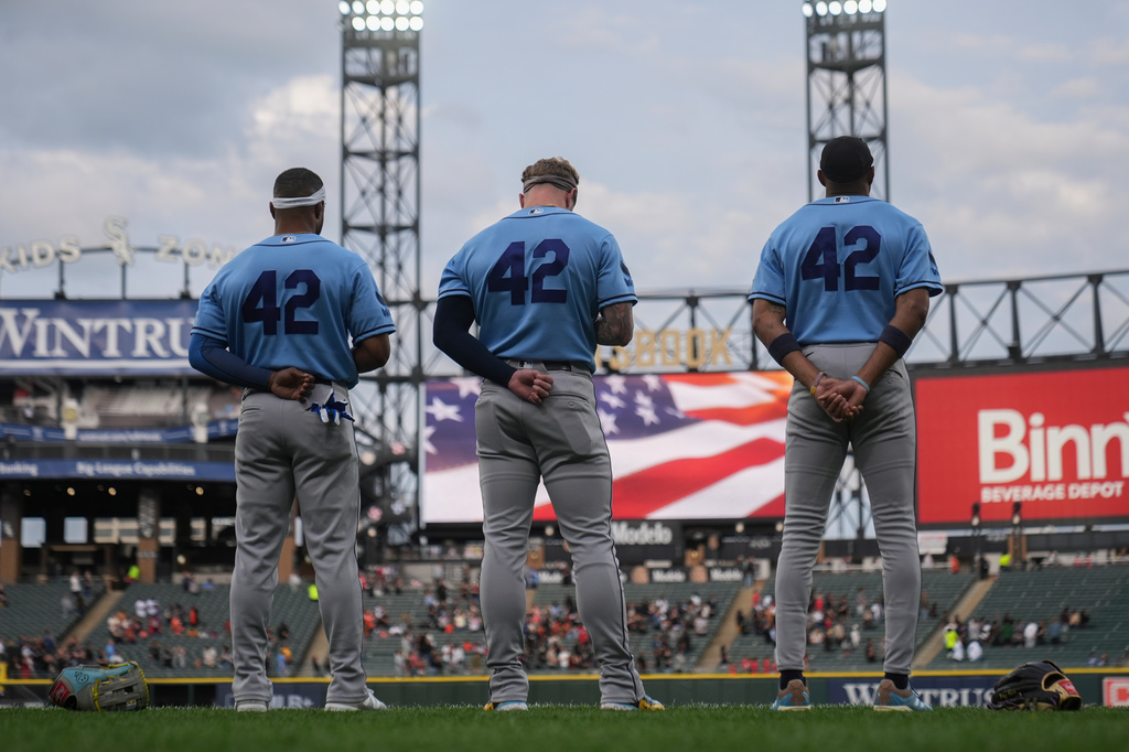 The Tampa Bay Rays stands for the Star-Spangled Banner on Jackie Robinson Day before a baseball game against the Tampa Bay Rays, Wednesday, April 15, 2026, in Chicago. (AP Photo/Erin Hooley)
