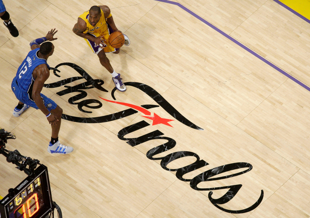 FILE - Los Angeles Lakers guard Kobe Bryant dribbles as Orlando Magic center Dwight Howard defends during the second half of Game 1 of the NBA basketball finals June 4, 2009, in Los Angeles. (AP Photo/Mark J. Terrill, File)