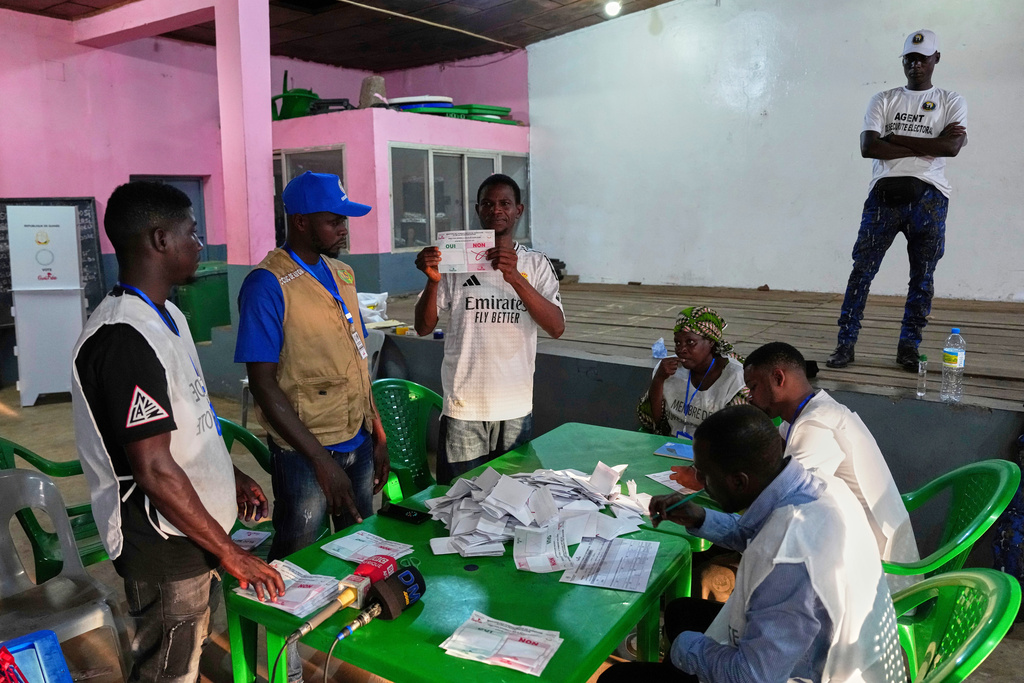Officials count ballots at a polling station as polls close during the constitutional referendum in Conakry, Guinea, Sunday, Sept. 21, 2025. (AP Photo/Misper Apawu)