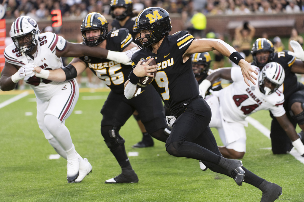 Missouri quarterback Beau Pribula (9) runs past South Carolina's Monkell Goodwine (44) and Gabriel Brownlow-Dindy (99) during the first half of an NCAA college football game Saturday, Sept. 20, 2025, in Columbia, Mo. (AP Photo/L.G. Patterson)